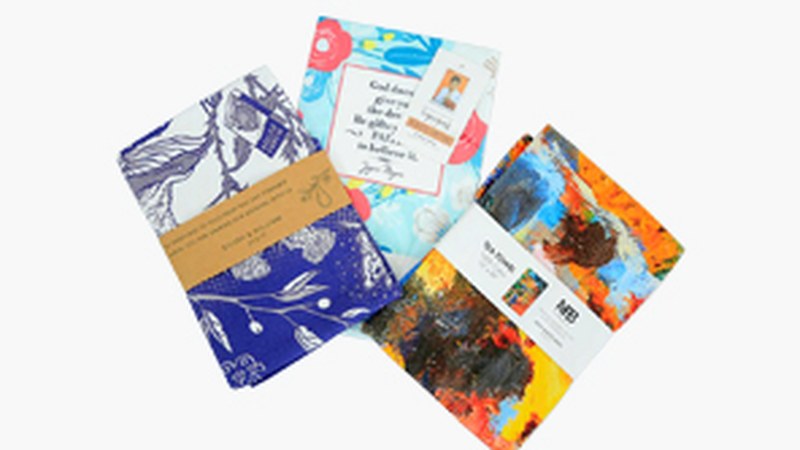 Small-batch custom tea towels folded with simple retail packaging.