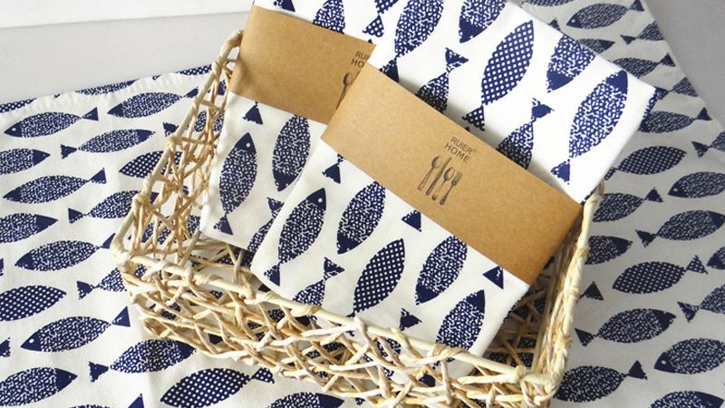 Folded custom cotton tea towels with simple retail packaging for a supplier check.